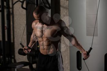 Man Is Working On His Chest With Cable Crossover In A Modern Gym