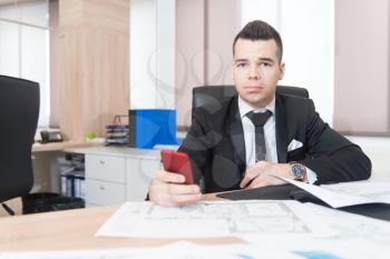 Young Handsome Businessman Working At Desk In The Modern Office Talking On Phone