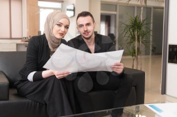 Happy Young Business Man And Muslim Woman Work In Modern Office On Computer