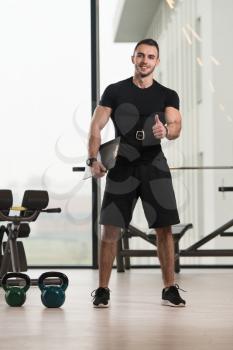 Handsome Personal Trainer With A Clipboard In Fitness Center Gym