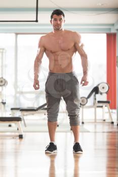 Handsome Young Model Standing Strong in the Fitness Center and Flexing Muscles - Muscular Athletic Bodybuilder Man Posing After Exercises