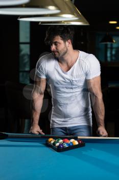 Portrait Of A Young Man Playing Billiards Pool Game