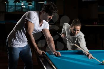 Young Caucasian Woman Receiving Advice On Shooting Pool Ball While Playing Billiards