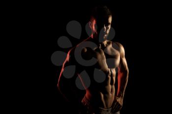 Silhouette Muscular Model Posing On Isolated On Black Background