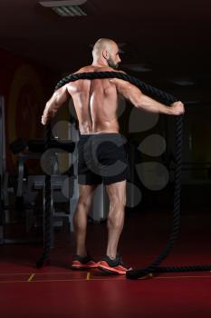 Man Battling Ropes At Gym Workout Exercise