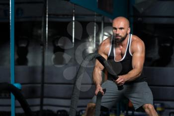 Man Battling Ropes At Gym Workout Exercise