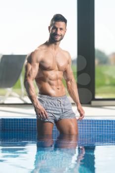 Young Healthy Good Looking Macho Man Model Athlete At Hotel Indoor Pool