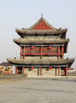 Front View of Bell Tower in Xian China with blue sky and birds in background
