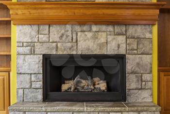 Natural Gas Insert Fireplace built with stone and wood