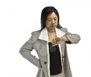 Asian woman dressed in business formal looking at wach on white background