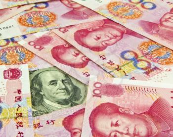 US Hundred dollar bill surrounded by Chinese Yuan