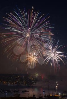 Large wheel shaped like fireworks off Lake Union Washington during 4th of July