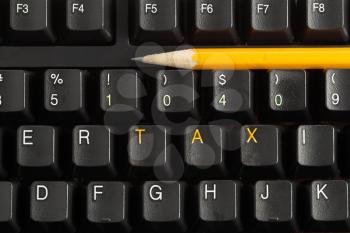Horizontal photo of a yellow pencil on keyboard with the letters Tax in Orange and 1040 in Yellow 