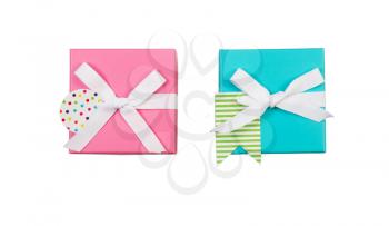 Top view of new pink and aqua color wrapped gift boxes and white bows isolated on white 