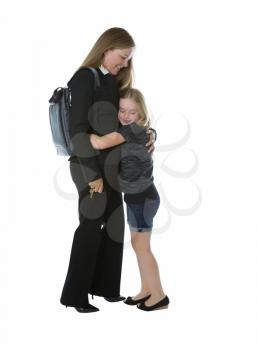 Side view of businesswoman and her young daughter hugging her when getting home from work while isolated on white background 