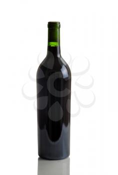 Vertical image of a full unlabeled single red wine bottle on white with reflection