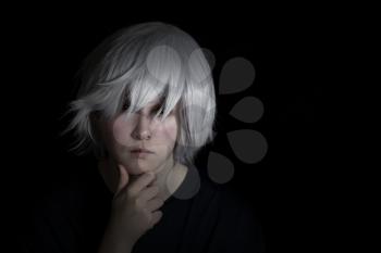Teen girl, looking forward, wearing silver wig on black background