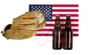 Top view angled shot of worn leather mitt, used baseball and full beer bottles with United States of America flag in background isolated on white. 