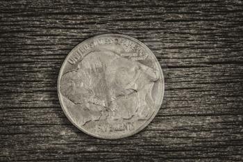 Vintage concept of Buffalo Nickel, reverse side, on rustic wood 