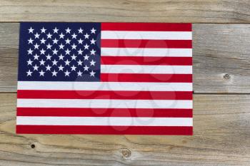 United States of America flag on rustic cedar wood. 