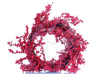 Red holly berry wreath isolated on white with reflection. 