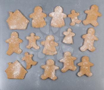 Raw homemade cookies for the holiday season on metal bake sheet. Family member and home shape for the special season. 