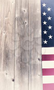 USA faded flag border on vertical rustic wooden boards. Vintage effect applied to image. 