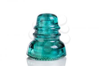 Close up of antique electric glass insulator isolated on white with reflection. 