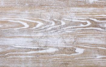 Rustic white wooden background covered in snow for Christmas concept. Overhead view with copy space.