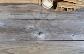 Overhead view of a top border of partial used baseball equipment on rustic wood