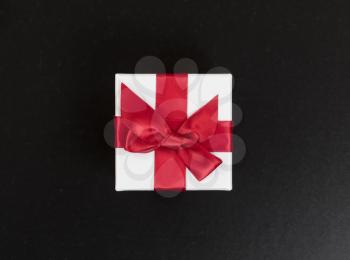 Overhead view of a gift box on dark stone background
