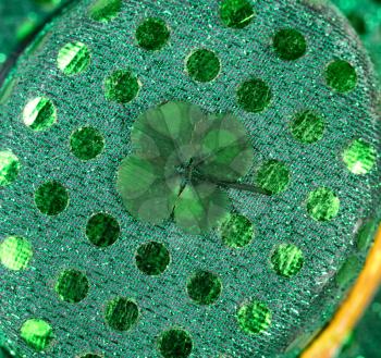 Real four leaf clover with shiny green background in close up view