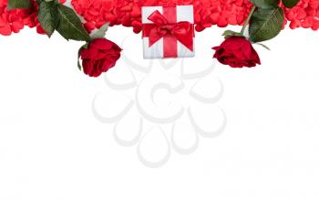 Red heart shapes, gift box and roses forming upper board on white background