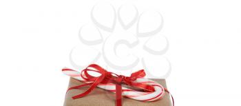 Top of Christmas giftbox and candy cane isolated on pure white background with plenty of copy space