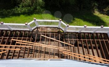Overhead view of aged outdoor wooden cedar deck being tore down 