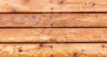 Overhead view of outdoor wooden stain deck boards with natural rain water on top of them