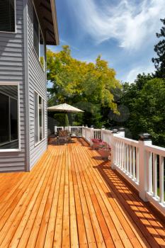 Brand new red cedar outdoor wooden deck during nice weather in vertical layout  