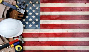 Labor Day concept with worker tools over distressed wooden United States Flag