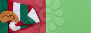 Red and green background with Elf cap for Christmas season 