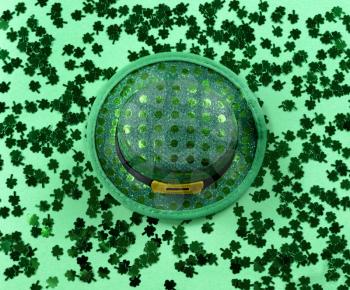 Saint Patricks Day with shamrocks and shiny hat on green background in filled frame format 