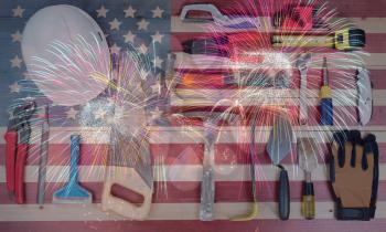 Labor Day holiday background for United States of America with worker tools and US flag with fireworks 
