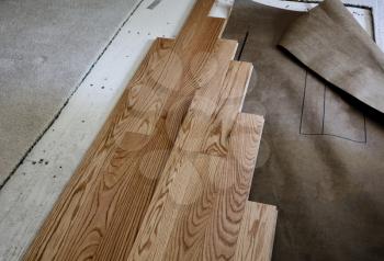 Renovation of home floor with exposed plywood and old carpet with new red oak wooden boards