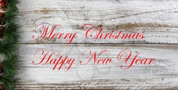 Christmas or New Year holiday background with left border of evergreen and red berries  plus text message