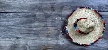 Traditional large sombrero hat for Cinco de Mayo holiday celebration on rustic wooden boards 