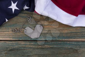 Waving American flag and military ID tags for Memorial Day, Labor Day and 4th of July holiday concepts 