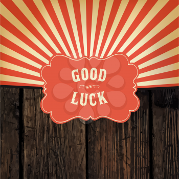 Wild west styled Good Luck message on wooden board. With red rays background