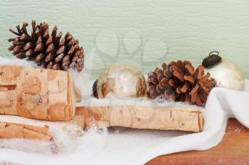 abstract composition from birch logs, Christmas balls and cones