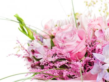 fragment of colorful bouquet of roses, cloves, orchids and freesia isolated on white background