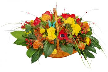 Flower bouquet arrangement centerpiece in a wicker gift basket isolated on white background.