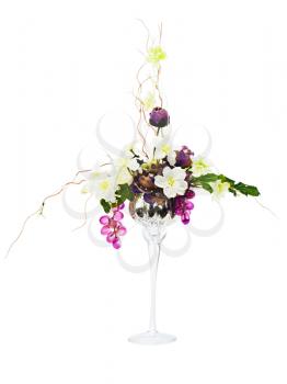 Floral arrangement from artificial flowers in glass goblet isolated on white background